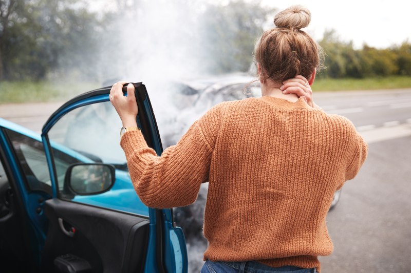 Women with whiplash Injury getting out of the car in Sandusky, OH